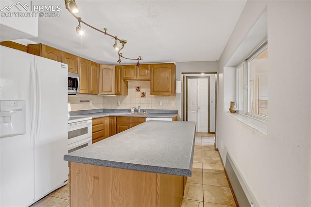 kitchen with a center island, white appliances, backsplash, sink, and light tile patterned floors