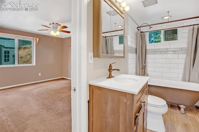 full bathroom with shower / bath combo, vanity, toilet, and ceiling fan