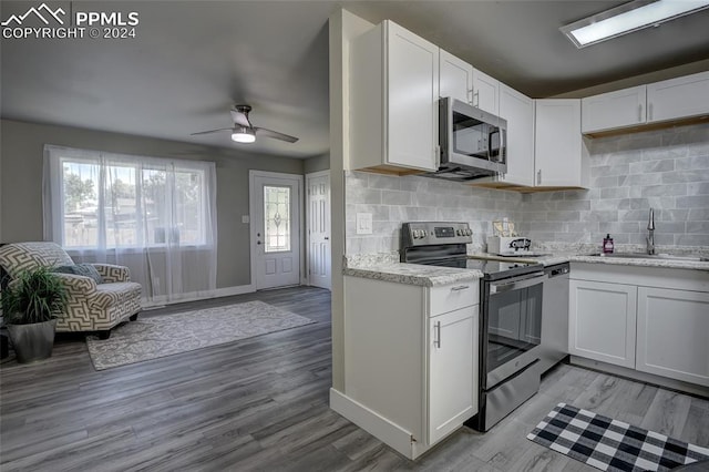 kitchen featuring plenty of natural light, sink, white cabinetry, and stainless steel appliances