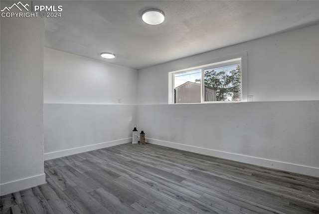 empty room with hardwood / wood-style flooring