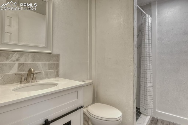 bathroom with walk in shower, hardwood / wood-style floors, toilet, decorative backsplash, and vanity