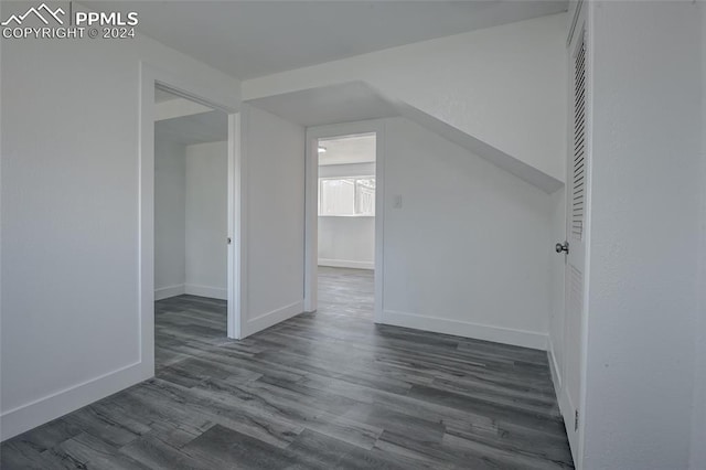 additional living space with dark hardwood / wood-style flooring