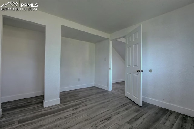 unfurnished room featuring dark hardwood / wood-style flooring