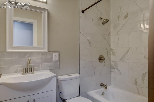 full bathroom featuring vanity, backsplash, tiled shower / bath, toilet, and tile walls