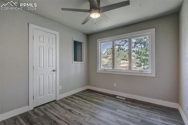 spare room featuring light hardwood / wood-style floors and ceiling fan