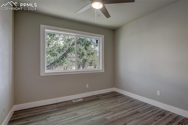 spare room featuring ceiling fan and light hardwood / wood-style floors