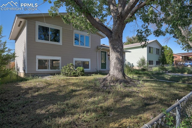 rear view of property featuring a yard