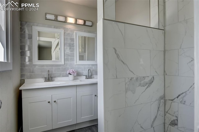 bathroom featuring tasteful backsplash, vanity, and tile walls