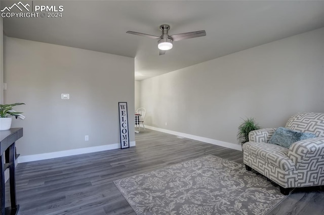 living area with dark hardwood / wood-style flooring and ceiling fan