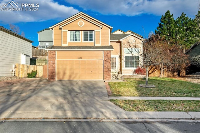 front facade featuring a garage and a front lawn