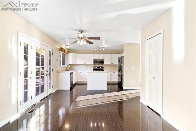 kitchen with stainless steel appliances, ceiling fan, sink, dark hardwood / wood-style floors, and white cabinetry