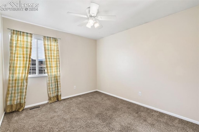 spare room featuring ceiling fan and carpet floors