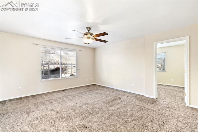 carpeted empty room with ceiling fan