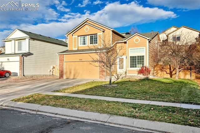 view of front facade featuring a front yard and a garage