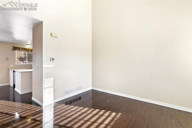 unfurnished room featuring dark hardwood / wood-style floors