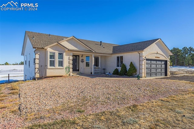 ranch-style home featuring a garage