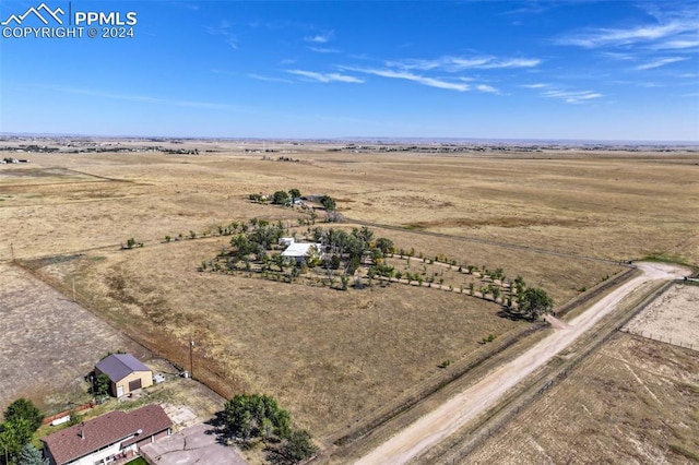 birds eye view of property with a rural view