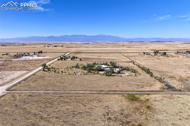 drone / aerial view featuring a mountain view and a rural view