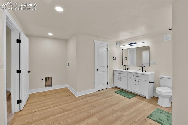 bathroom featuring hardwood / wood-style floors, vanity, and toilet