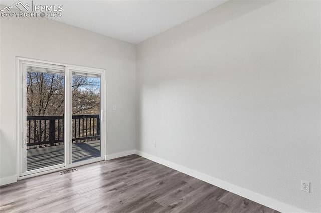 empty room with hardwood / wood-style floors