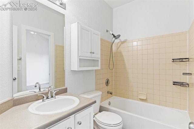 full bathroom featuring vanity, toilet, and tiled shower / bath combo