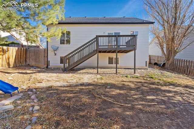 back of house with a wooden deck