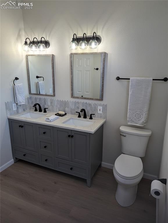 bathroom with vanity, hardwood / wood-style flooring, and toilet