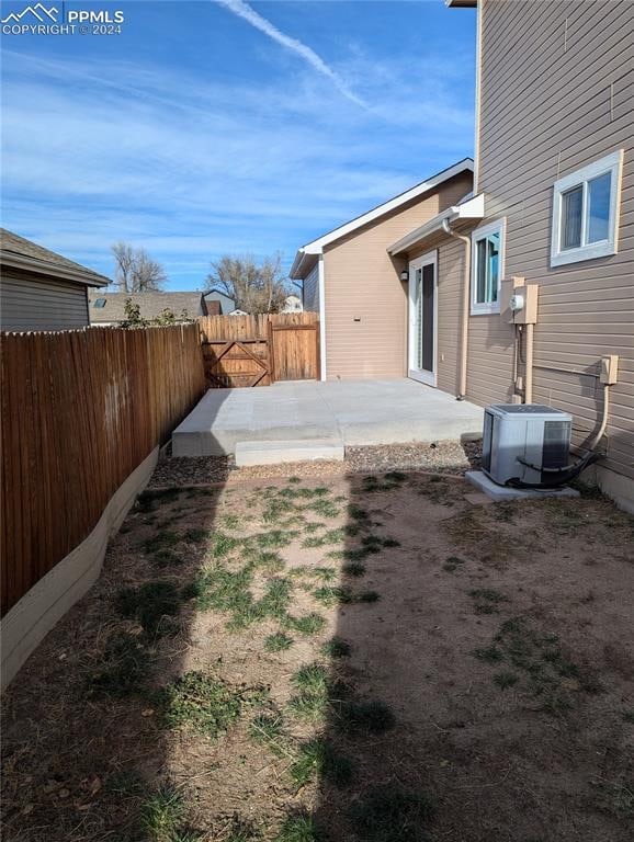 view of yard featuring central AC and a patio area