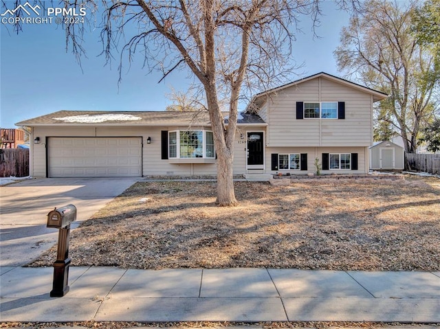 split level home with a shed and a garage