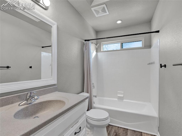 full bathroom featuring vanity, toilet, wood-type flooring, and shower / tub combo with curtain