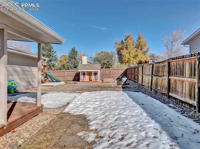 yard covered in snow with a patio