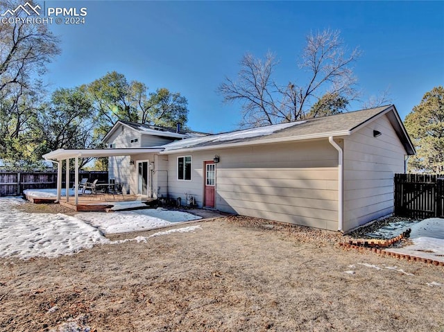 back of house featuring a wooden deck and a patio area