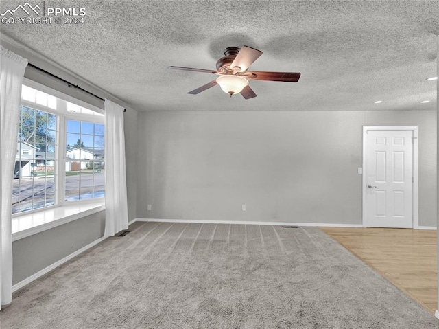 unfurnished room featuring light wood-type flooring, a textured ceiling, and ceiling fan