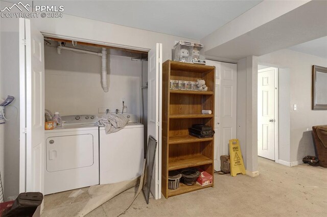 laundry room featuring independent washer and dryer and light carpet