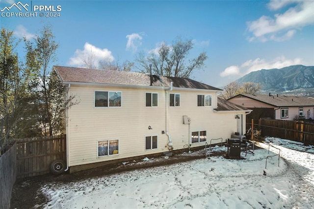 snow covered house with a mountain view