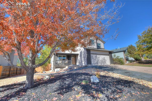 view of front facade featuring covered porch and a garage