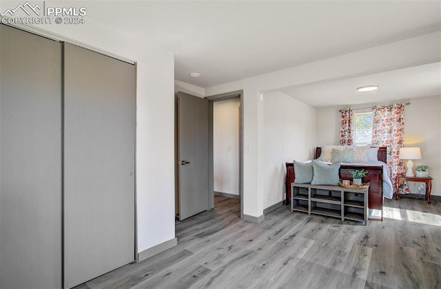 bedroom with a closet and light hardwood / wood-style flooring