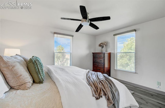 bedroom with ceiling fan and dark wood-type flooring