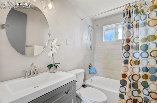 full bathroom featuring shower / bath combo, vanity, and toilet