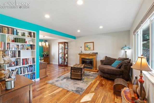 living room featuring hardwood / wood-style floors and an inviting chandelier