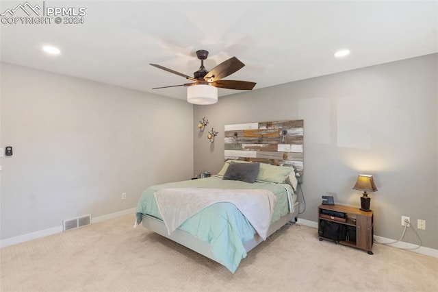 bedroom with ceiling fan and light colored carpet