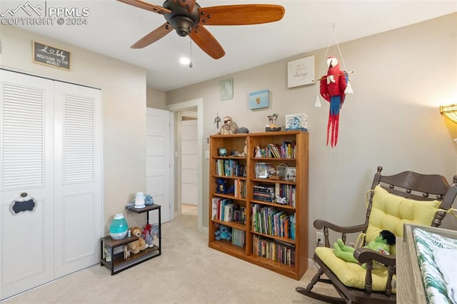 living area with ceiling fan and light colored carpet