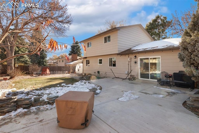 snow covered property with a patio area