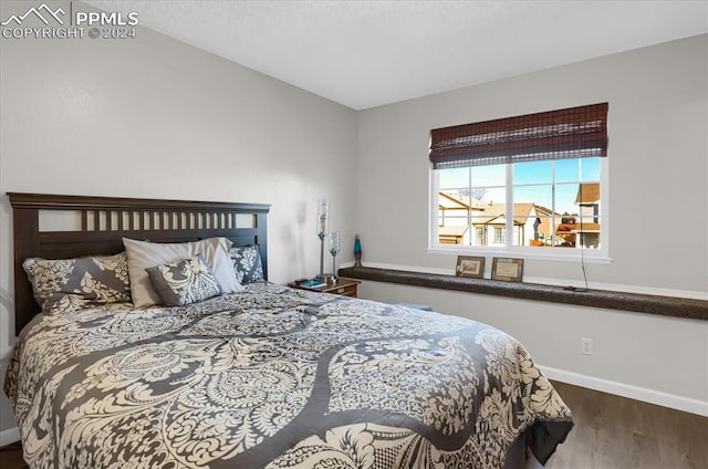 bedroom with hardwood / wood-style floors