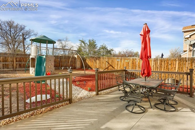 wooden deck featuring a playground