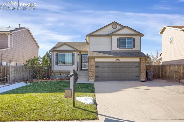 view of front of property with a front lawn and a garage