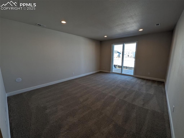 carpeted spare room featuring a textured ceiling