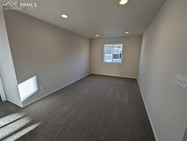 empty room with dark colored carpet