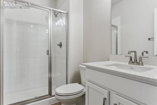 bathroom featuring walk in shower, vanity, and toilet