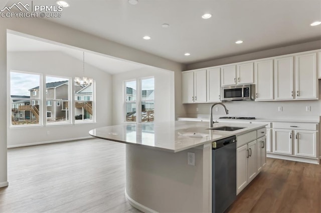 kitchen with sink, white cabinetry, a center island with sink, dishwasher, and a healthy amount of sunlight